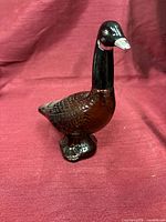 Front view of amber glass Canada goose decanter