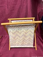 Front view of folding sewing basket showing wooden frame and fabric bag
