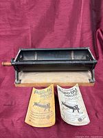 Paper log roller with two instruction booklets displayed