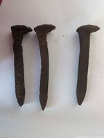 Front view of all three iron railroad spikes