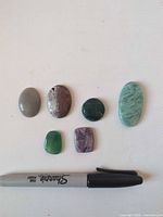 All six cabochons with Sharpie for scale