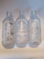 Front view of three clear textured Pepsi bottles