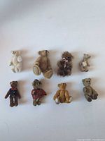 Group shot of eight miniature teddy bears