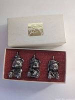 Three pewter teddy bear ornaments in open box