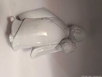 Full view of white glazed porcelain Buddha / Hotei figurine lying on side