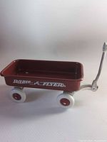 Side view of red miniature Radio Flyer wagon