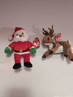 Santa and reindeer Ty plush side by side