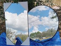 Front view showing rectangular and round mirrors reflecting sky