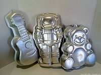 front view of all three shaped cake pans standing upright