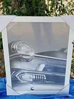 front view of sealed framed classic car print showing photo and white frame with protective corners
