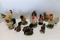 Group shot of all rooster and chicken figurines upright