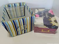 Fabric bin open next to sealed floral photo box