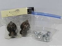 Finials in original package beside zip bag of crystal knobs