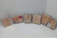 Full view of six plastic cases with all stamps