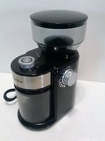 Front view showing controls, hopper, container, power cord