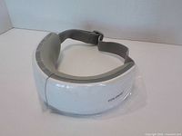 Front view of TOLOCO eye massager visor with protective film