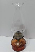Full view of assembled amber glass oil lamp