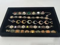 Top view of five bracelets in tray