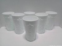 Front view of six milk glass tumblers