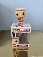 Figure standing on top of its original box showing front artwork and branding