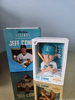 Bobblehead in front of original box