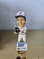 Front view of Pat Borders bobblehead with trophy and base branding visible
