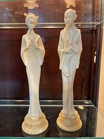 Front view of both alabaster figures standing on bases
