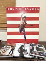 Full view of poster and three books