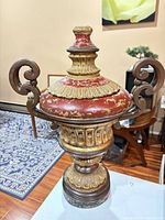 Full view of urn showing handles, lid and base