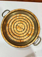 Top view showing full round brass tray with bone inlay pattern and both handles