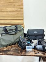 Group shot of both camcorders, two bags and accessories