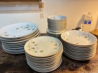 Stacks of assorted Woodland pattern plates and bowls