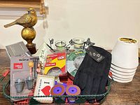 Overall lot showing all items in basket, lamp shades and bird figurine