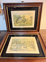 Both framed prints displayed together open on table