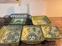 Four nesting square Old World Green bowls and two wire trays displayed