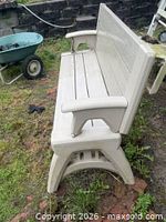Side view of beige resin bench in bench position