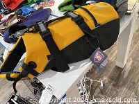 Full view of yellow/black life jacket with tag attached