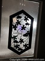 Full view of grapevine metal art hanging in window