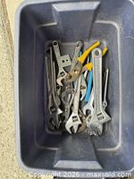 Bin containing adjustable wrenches and pliers