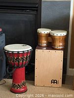 Djembe, bongos and cajon grouped in front of fireplace