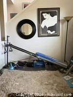 Full view of Total Gym assembled showing glideboard, rails, cables and accessories on floor