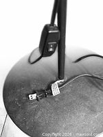Round weighted base with power cord and inline rocker switch visible