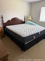 Full view of king bed with headboard, mattress and box spring