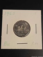 Obverse and reverse views of 1962 Canadian 5-cent coin in flip