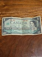 Obverse of 1967 Centennial $1 note showing Queen Elizabeth II and dates 1867 1967