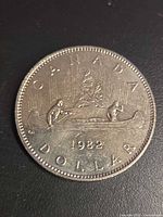 Reverse of 1982 Voyageur dollar showing canoe design