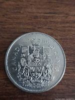 Reverse of 1992 Canadian 50-cent coin showing Coat of Arms and denomination