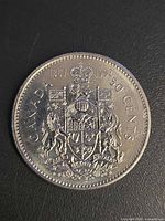 Reverse view with Canadian Coat of Arms, dual dates 1867-1992, denomination 50 Cents