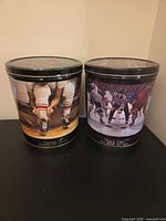 Two Ken Danby collectible tins side by side