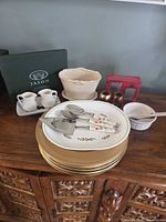 Overview with chargers, Christmas plate, creamers, Jason placemat box, silver-plate gift set, napkin rings, ceramic container